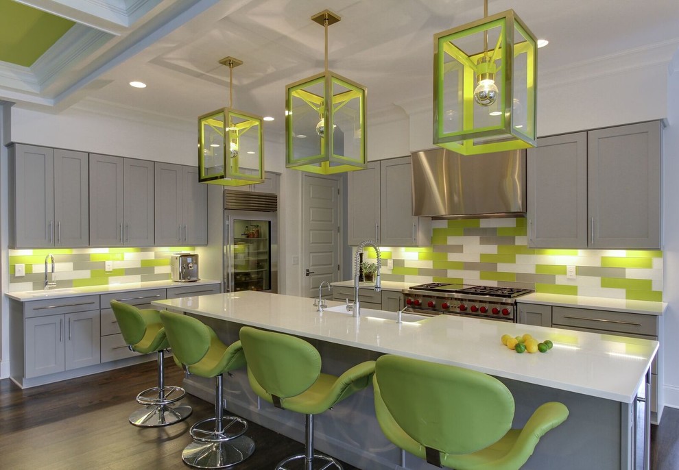 Mid-sized trendy l-shaped dark wood floor and brown floor open concept kitchen photo in Other with an island, shaker cabinets, gray cabinets, multicolored backsplash, stainless steel appliances, a farmhouse sink, quartzite countertops, glass tile backsplash and white countertops