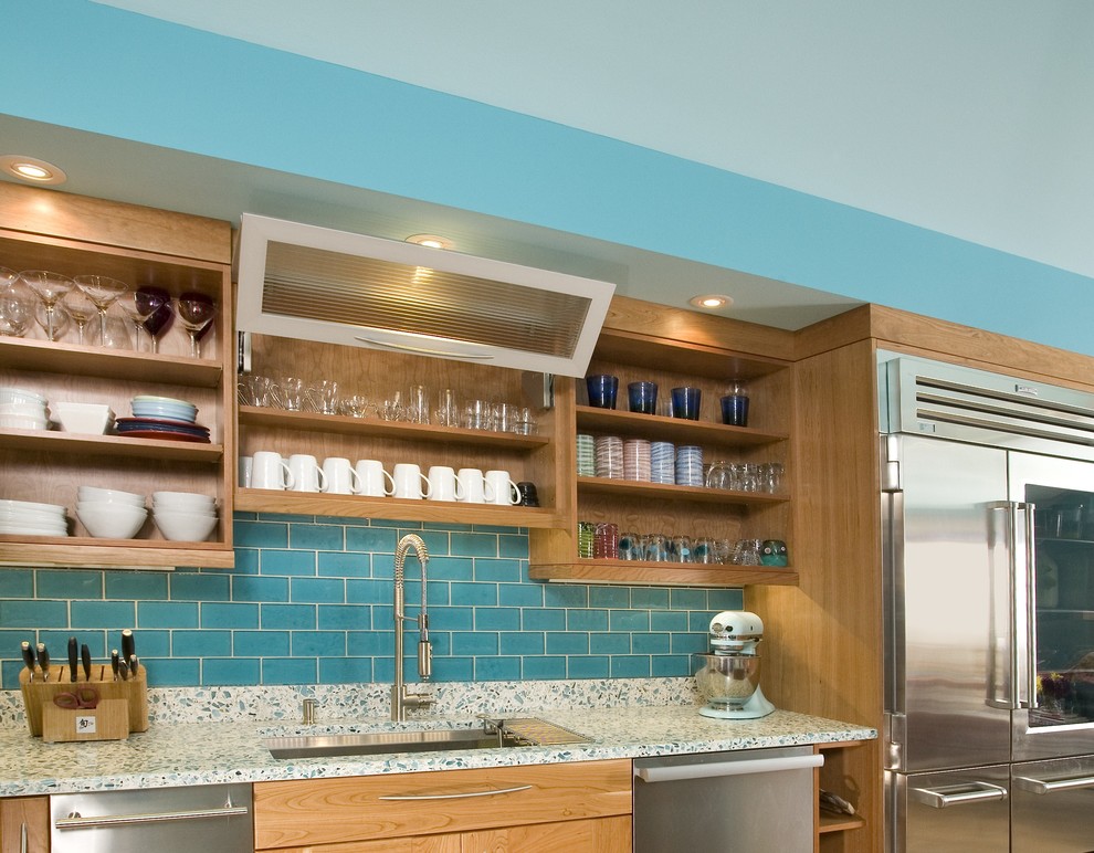 Photo of a large contemporary single-wall open plan kitchen in Seattle with a submerged sink, open cabinets, light wood cabinets, recycled glass countertops, blue splashback, metro tiled splashback, stainless steel appliances, medium hardwood flooring, an island and turquoise worktops.