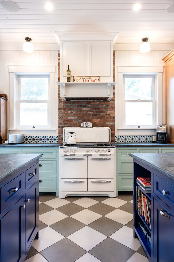 Example of a large eclectic u-shaped porcelain tile and multicolored floor eat-in kitchen design in San Luis Obispo with a double-bowl sink, shaker cabinets, blue cabinets, multicolored backsplash, brick backsplash, two islands and gray countertops