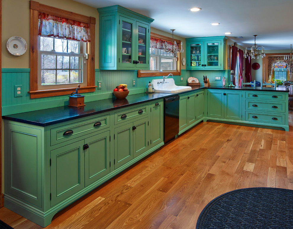Mid-sized eclectic l-shaped medium tone wood floor eat-in kitchen photo in Providence with beaded inset cabinets, green cabinets, soapstone countertops, green backsplash, wood backsplash, no island, a drop-in sink and black appliances