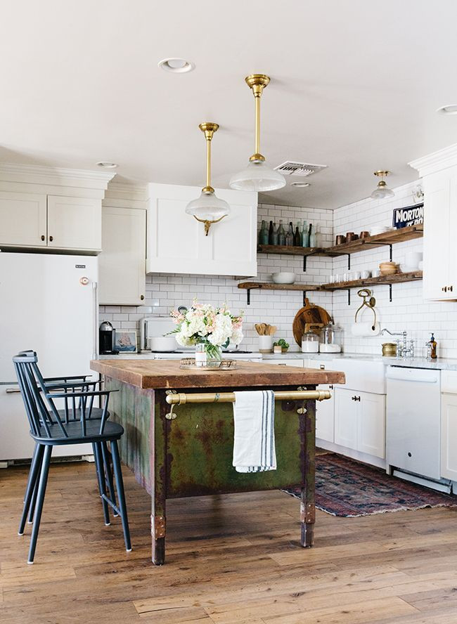 Inspiration for a mid-sized eclectic l-shaped light wood floor and brown floor open concept kitchen remodel in Columbus with a farmhouse sink, shaker cabinets, white cabinets, marble countertops, white backsplash, subway tile backsplash, white appliances, an island and white countertops