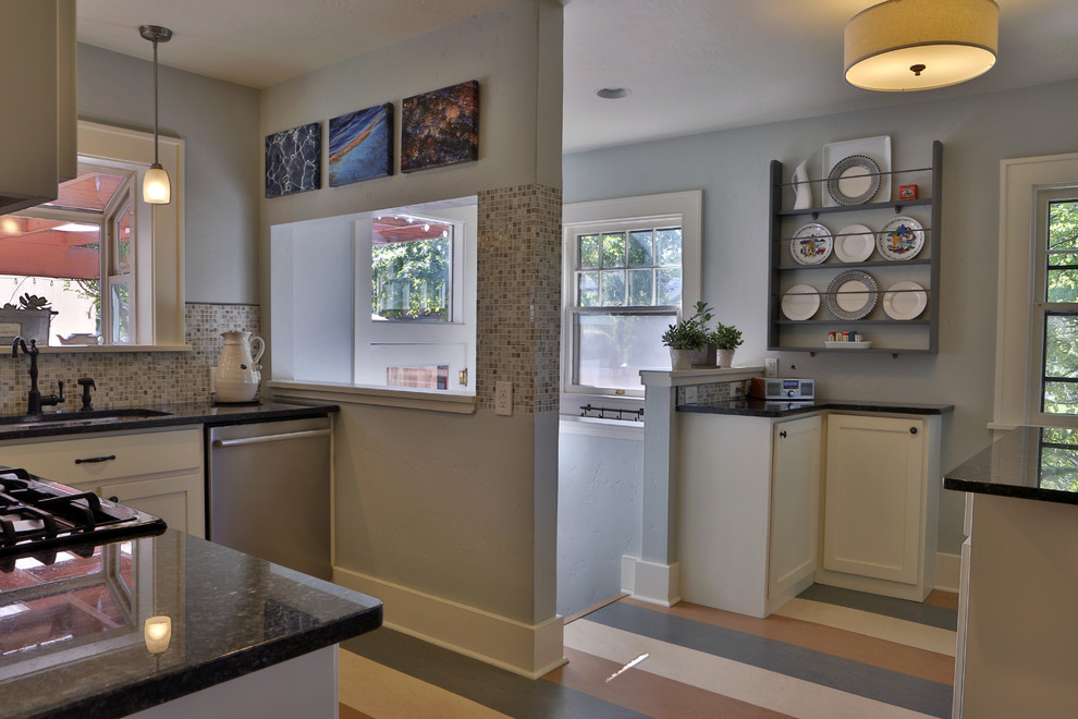 Small eclectic l-shaped linoleum floor eat-in kitchen photo in Boise with an undermount sink, recessed-panel cabinets, yellow cabinets, granite countertops, multicolored backsplash, mosaic tile backsplash, stainless steel appliances and an island