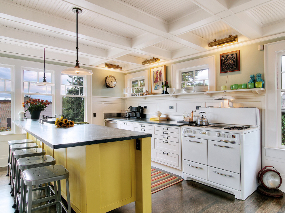 Eclectic galley kitchen in Seattle with white appliances.