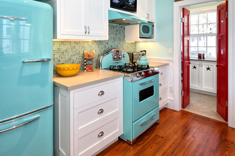 Inspiration for a mid-century modern kitchen remodel in Philadelphia with colored appliances, concrete countertops, shaker cabinets and white cabinets