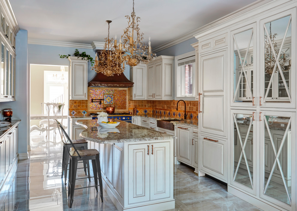Enclosed kitchen - large traditional u-shaped porcelain tile and beige floor enclosed kitchen idea in Chicago with a farmhouse sink, raised-panel cabinets, white cabinets, granite countertops, orange backsplash, terra-cotta backsplash, paneled appliances, an island and gray countertops