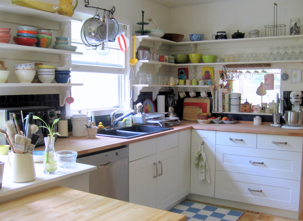 Inspiration for a bohemian kitchen in Burlington with wood worktops, open cabinets and a built-in sink.