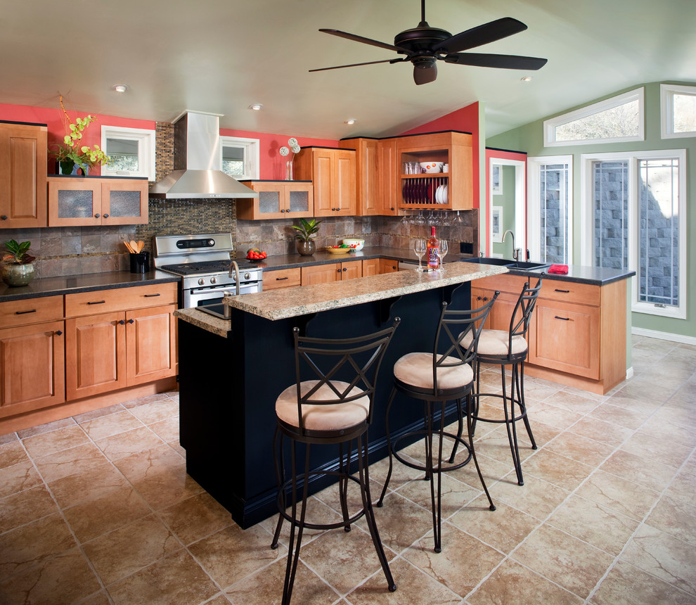 Large minimalist u-shaped ceramic tile eat-in kitchen photo in Omaha with a double-bowl sink, raised-panel cabinets, light wood cabinets, laminate countertops, beige backsplash, stone tile backsplash, stainless steel appliances and an island