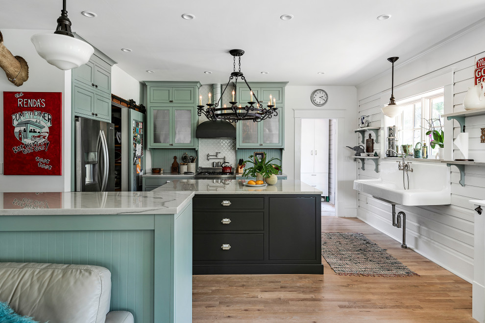 Inspiration for a large country l-shaped kitchen/diner in Jacksonville with a belfast sink, shaker cabinets, green cabinets, stainless steel appliances, medium hardwood flooring and multiple islands.