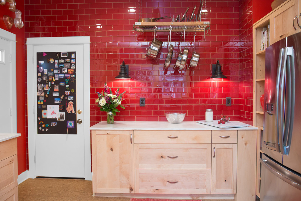 Example of a mid-sized eclectic u-shaped cork floor and beige floor enclosed kitchen design in Portland with a double-bowl sink, shaker cabinets, light wood cabinets, marble countertops, red backsplash, porcelain backsplash, stainless steel appliances and a peninsula