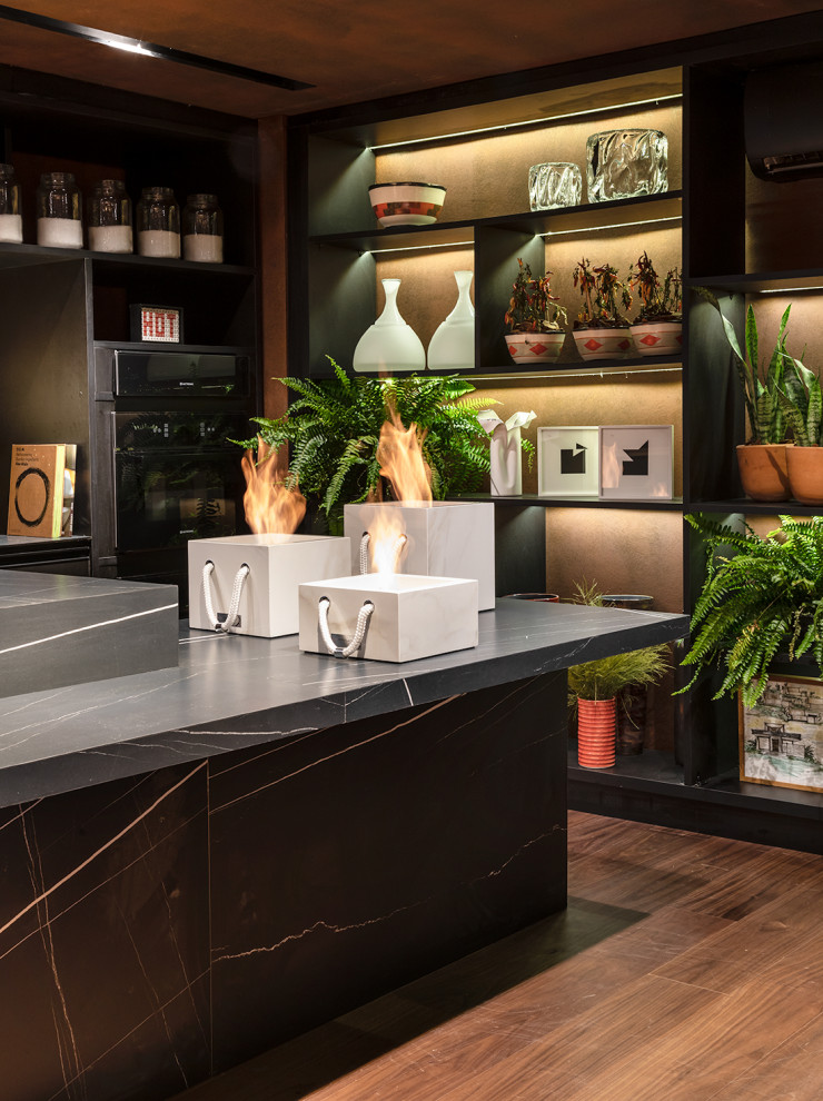 Example of a large trendy l-shaped vinyl floor and brown floor eat-in kitchen design in Miami with an integrated sink, raised-panel cabinets, black cabinets, marble countertops, an island and black countertops