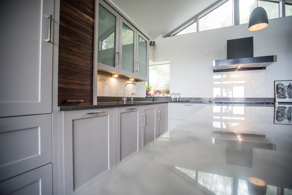 Inspiration for an expansive contemporary kitchen in Cornwall with a double-bowl sink, grey cabinets, engineered stone countertops, ceramic flooring and an island.
