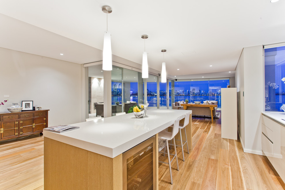 Kitchen - contemporary light wood floor kitchen idea in Perth with flat-panel cabinets, white cabinets and an island