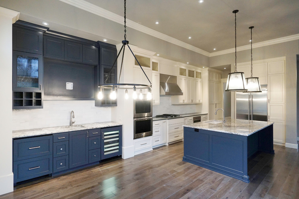 Mid-sized transitional l-shaped medium tone wood floor and gray floor eat-in kitchen photo in Portland with an undermount sink, shaker cabinets, blue cabinets, granite countertops, white backsplash, marble backsplash, stainless steel appliances and an island