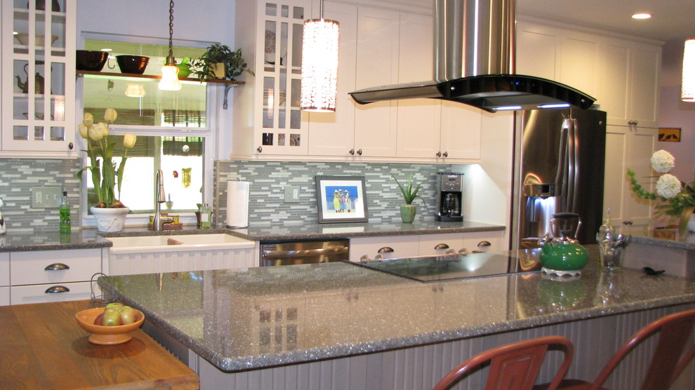 Medium sized traditional l-shaped kitchen/diner in Orlando with a belfast sink, shaker cabinets, white cabinets, engineered stone countertops, green splashback, porcelain splashback, stainless steel appliances, porcelain flooring and an island.