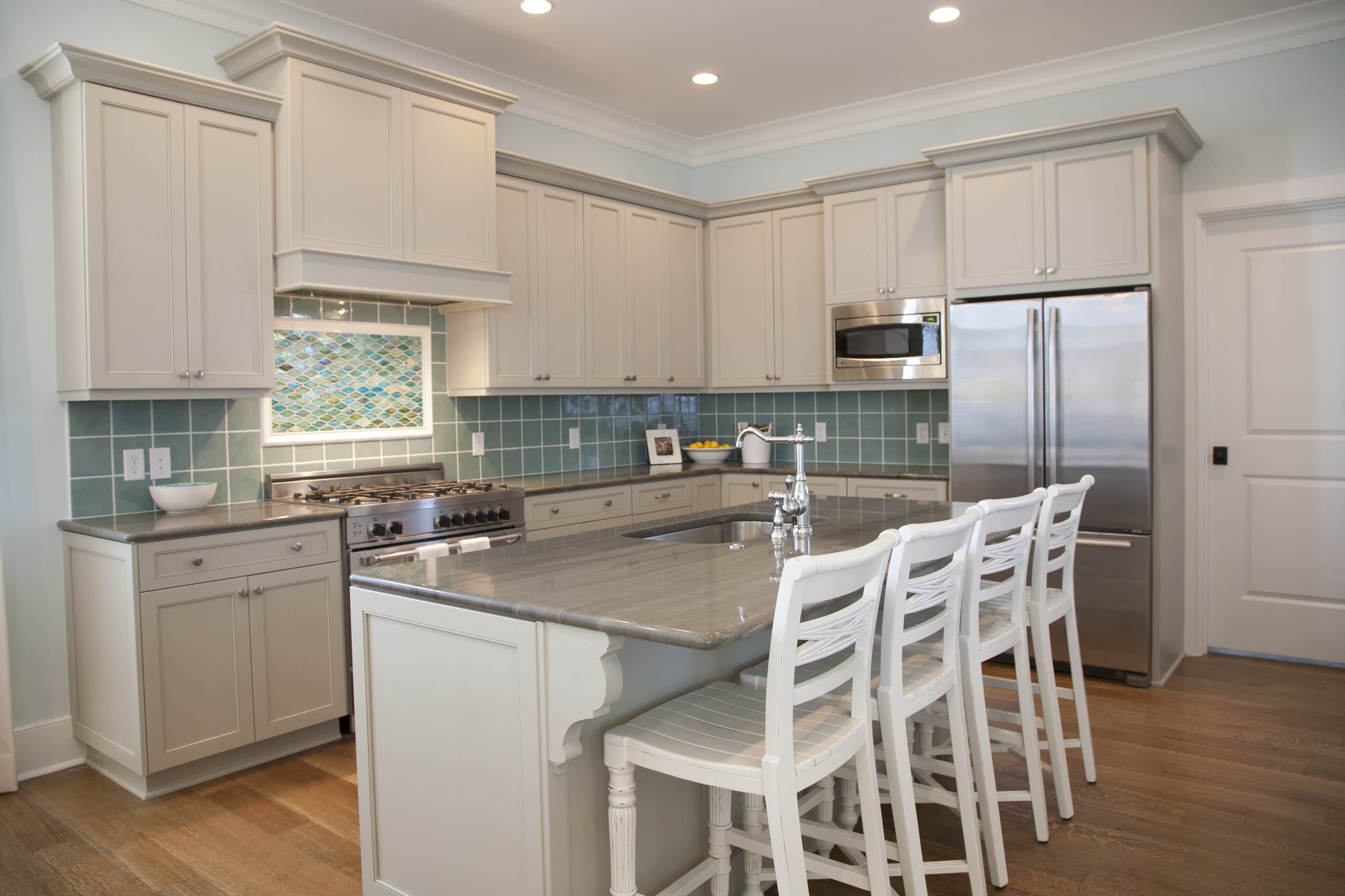 Gorgeous two story kitchen, granite countertops, pendant lighting, blue  mosaic backsplash tile, g…