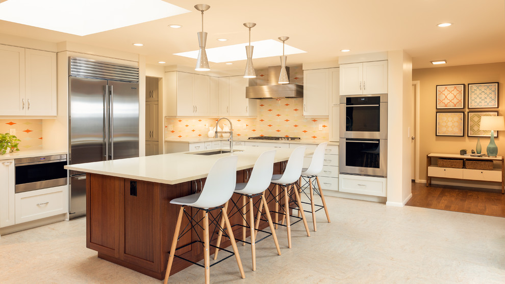 Large trendy u-shaped vinyl floor and beige floor eat-in kitchen photo in Portland with an undermount sink, recessed-panel cabinets, white cabinets, quartz countertops, multicolored backsplash, porcelain backsplash, stainless steel appliances and an island