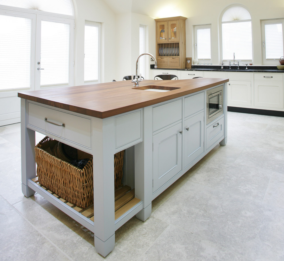 Large traditional kitchen/diner in Edinburgh with wood worktops and an island.