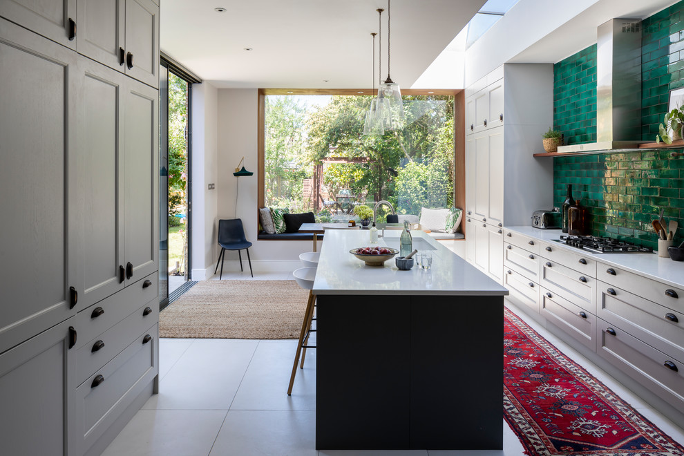 Design ideas for a large contemporary open plan kitchen in London with composite countertops, green splashback, an island, grey floors, a submerged sink, recessed-panel cabinets, grey cabinets and white worktops.