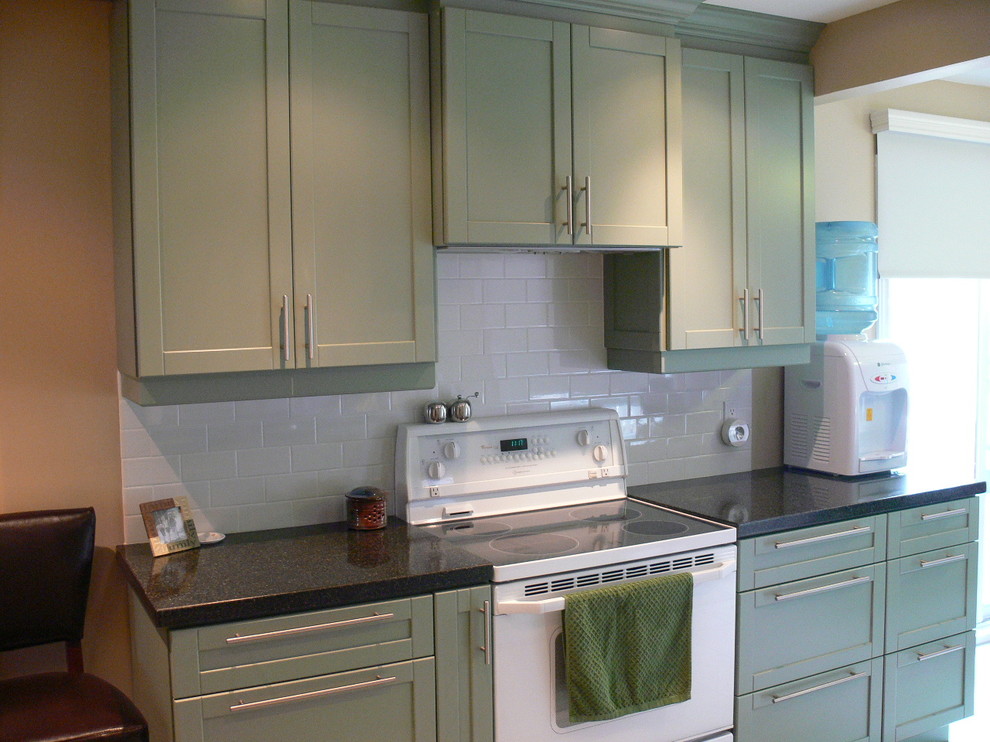 This is an example of a large contemporary u-shaped enclosed kitchen in Toronto with a double-bowl sink, shaker cabinets, green cabinets, granite worktops, white splashback, glass tiled splashback, white appliances, porcelain flooring and no island.
