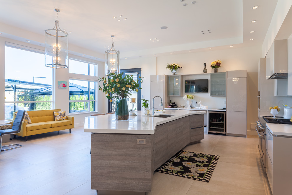 Example of a huge trendy galley porcelain tile and beige floor open concept kitchen design in Vancouver with a double-bowl sink, flat-panel cabinets, beige cabinets, quartzite countertops, white backsplash, an island and paneled appliances