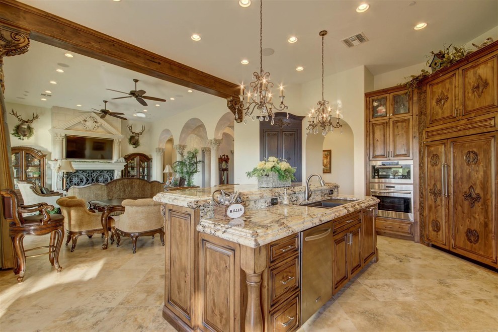 Example of a large tuscan l-shaped porcelain tile and beige floor open concept kitchen design in Phoenix with an undermount sink, beaded inset cabinets, medium tone wood cabinets, granite countertops, multicolored backsplash, mosaic tile backsplash, paneled appliances, an island and multicolored countertops