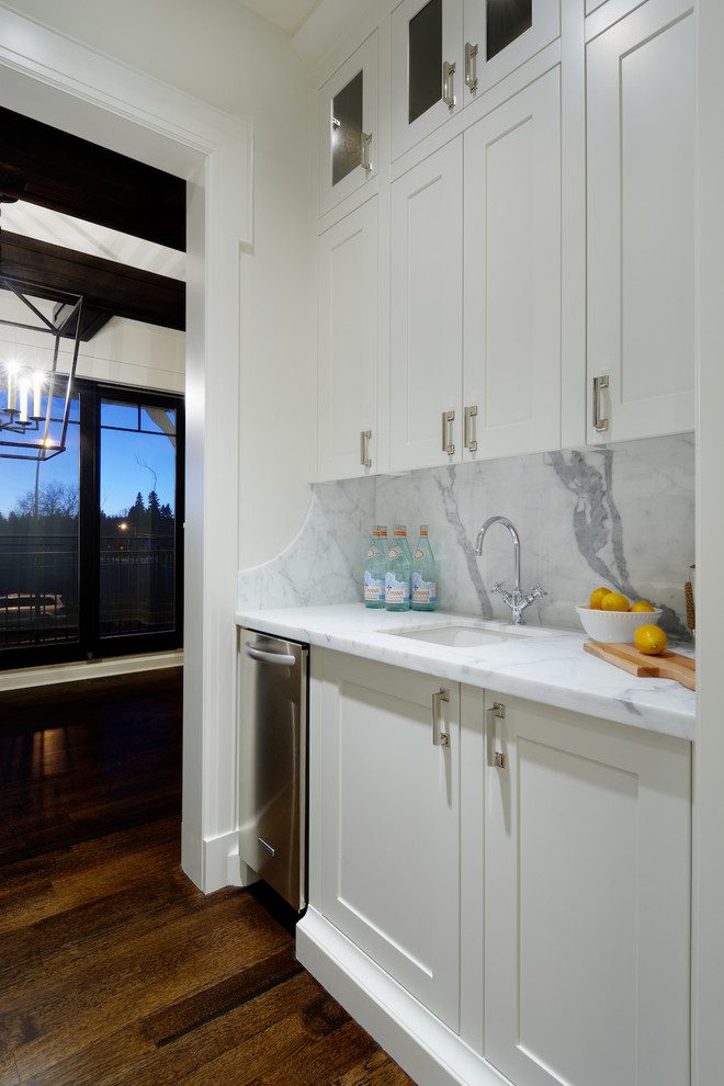 Transitional kitchen photo in Calgary with marble countertops and stone slab backsplash