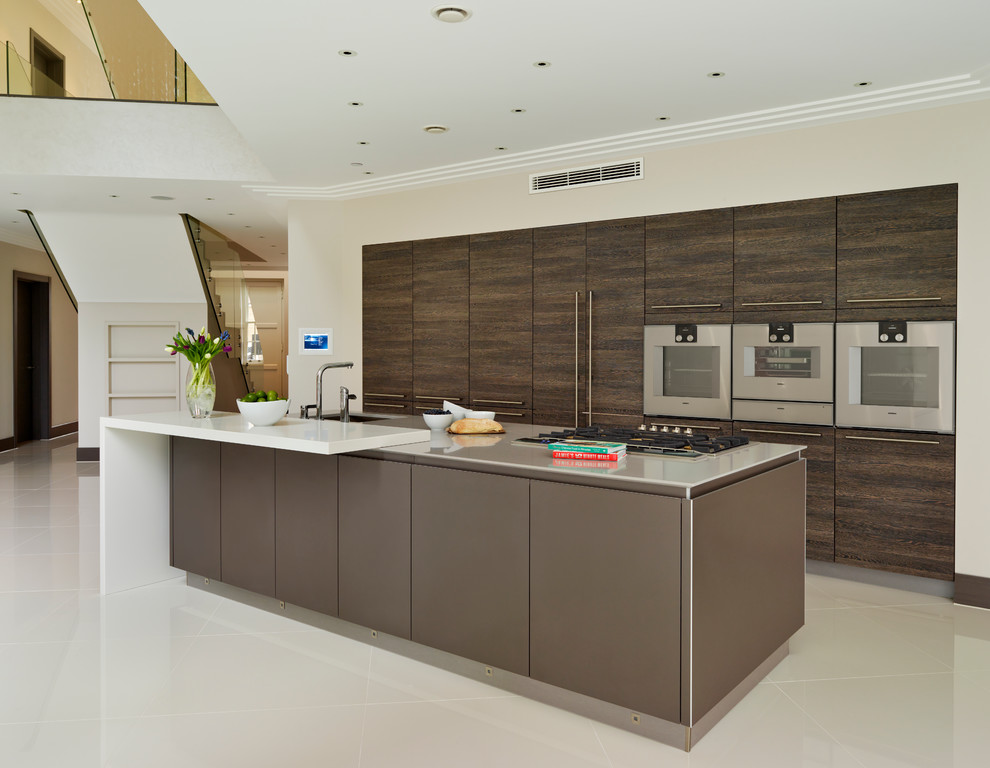 Contemporary kitchen in Essex with a submerged sink, flat-panel cabinets, dark wood cabinets, stainless steel appliances and an island.