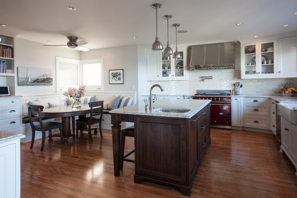 Inspiration for a large timeless single-wall medium tone wood floor eat-in kitchen remodel in Seattle with a farmhouse sink, shaker cabinets, white cabinets, quartz countertops, white backsplash, subway tile backsplash, colored appliances and an island