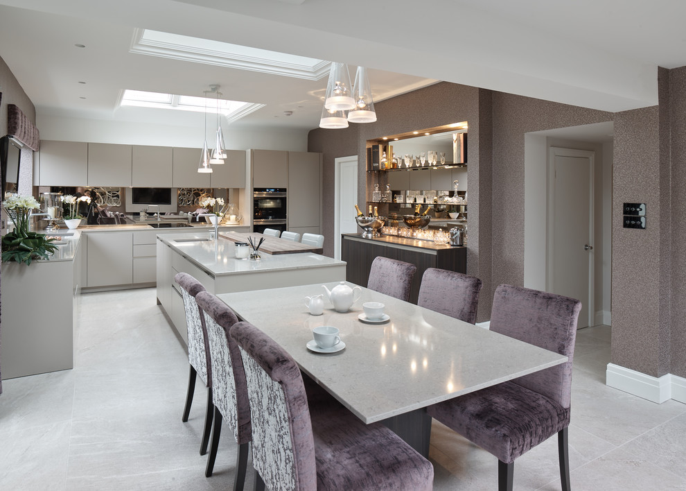 Inspiration for a large traditional l-shaped kitchen/diner in Other with a built-in sink, flat-panel cabinets, beige cabinets, quartz worktops, brown splashback, mirror splashback, black appliances, porcelain flooring, an island and grey floors.