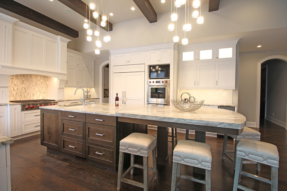 Inspiration for a huge transitional u-shaped dark wood floor and brown floor eat-in kitchen remodel in Detroit with an undermount sink, shaker cabinets, white cabinets, quartz countertops, white backsplash, stone tile backsplash, stainless steel appliances, an island and gray countertops