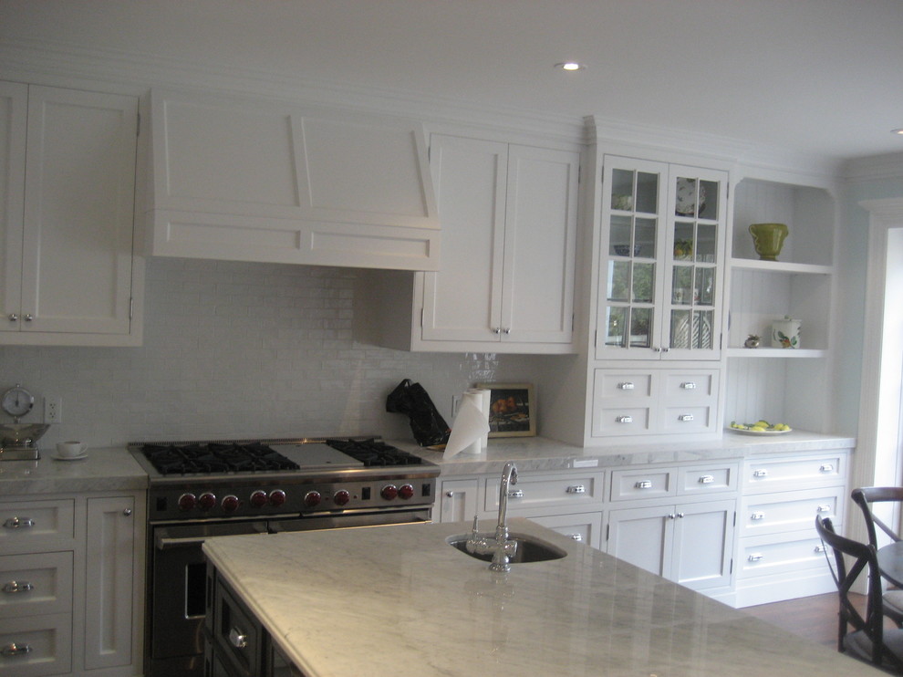 Elegant l-shaped eat-in kitchen photo in Toronto with an undermount sink, recessed-panel cabinets, white cabinets, marble countertops, white backsplash, subway tile backsplash and paneled appliances