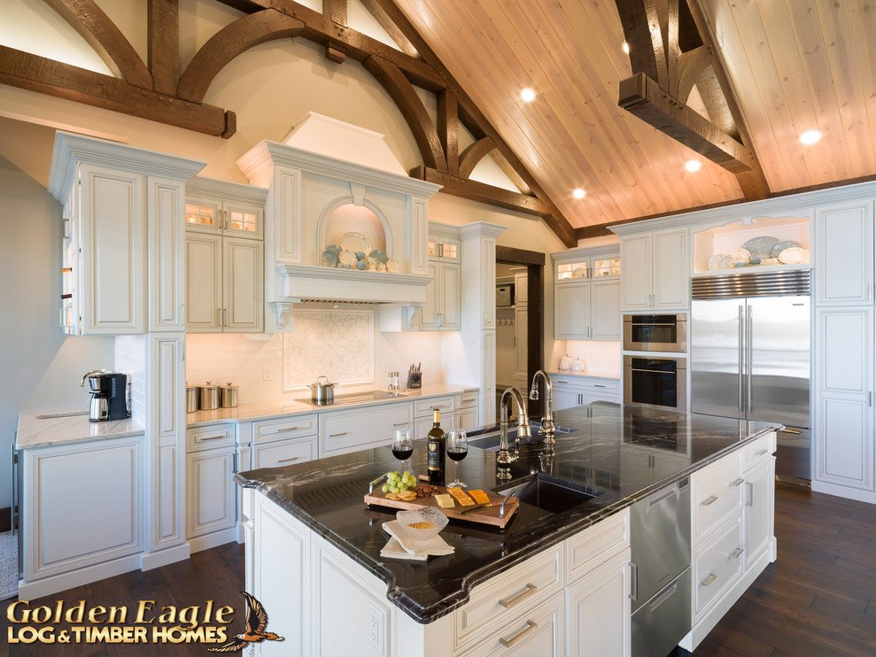 Photo of an expansive rustic kitchen/diner in Other with a double-bowl sink, raised-panel cabinets, white cabinets, granite worktops, red splashback, metro tiled splashback, stainless steel appliances, dark hardwood flooring and multicoloured worktops.