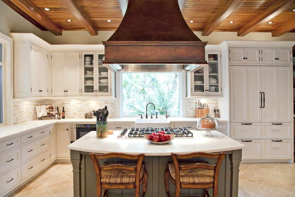 Eat-in kitchen - mid-sized traditional u-shaped limestone floor eat-in kitchen idea in Charleston with shaker cabinets, a farmhouse sink, white cabinets, marble countertops, beige backsplash, matchstick tile backsplash, stainless steel appliances and an island