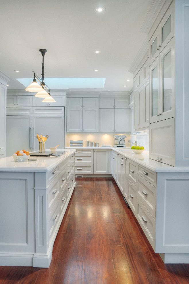Diseño de cocina clásica con armarios con paneles empotrados, puertas de armario blancas y electrodomésticos con paneles