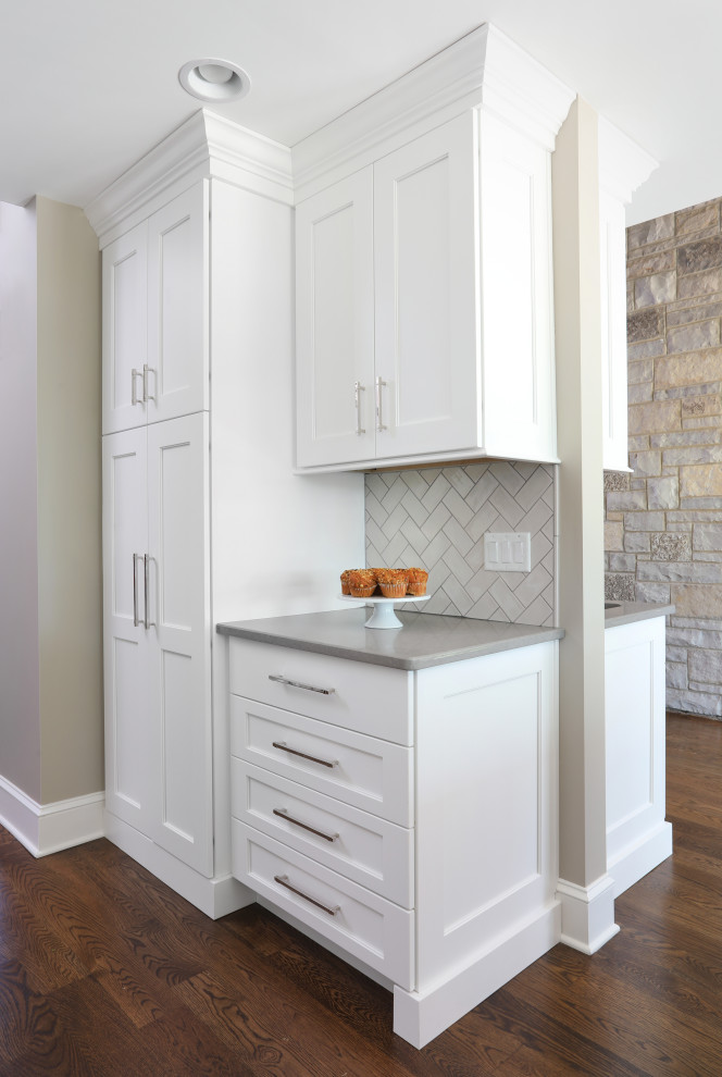 Transitional single-wall brown floor and medium tone wood floor eat-in kitchen photo in Chicago with white cabinets, gray backsplash, ceramic backsplash, gray countertops, recessed-panel cabinets and quartzite countertops