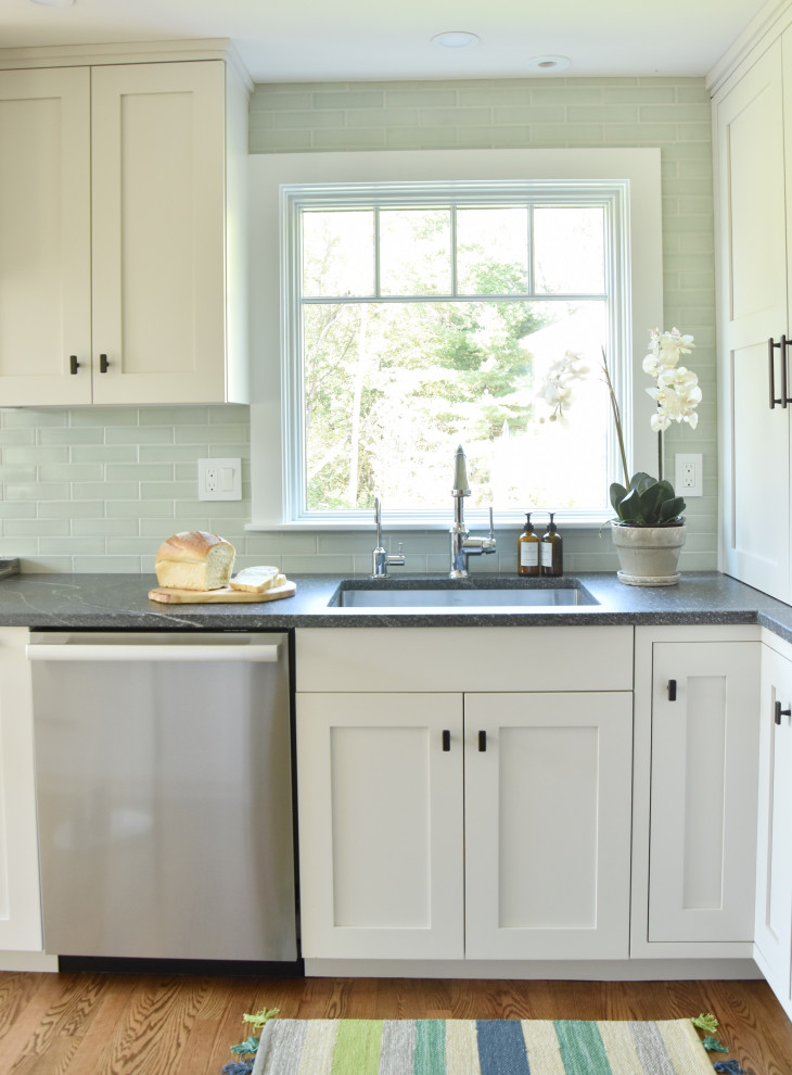 Inspiration for a kitchen in Boston with recessed-panel cabinets, granite worktops, ceramic splashback, stainless steel appliances, medium hardwood flooring, an island, grey worktops and white cabinets.