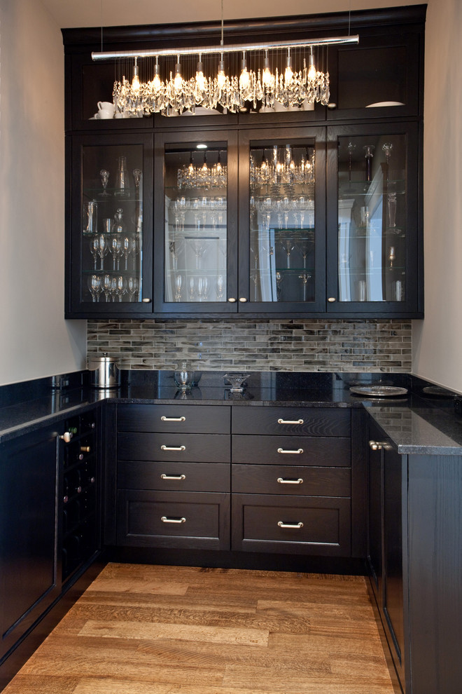 Design ideas for a classic u-shaped kitchen in DC Metro with medium hardwood flooring and black cabinets.