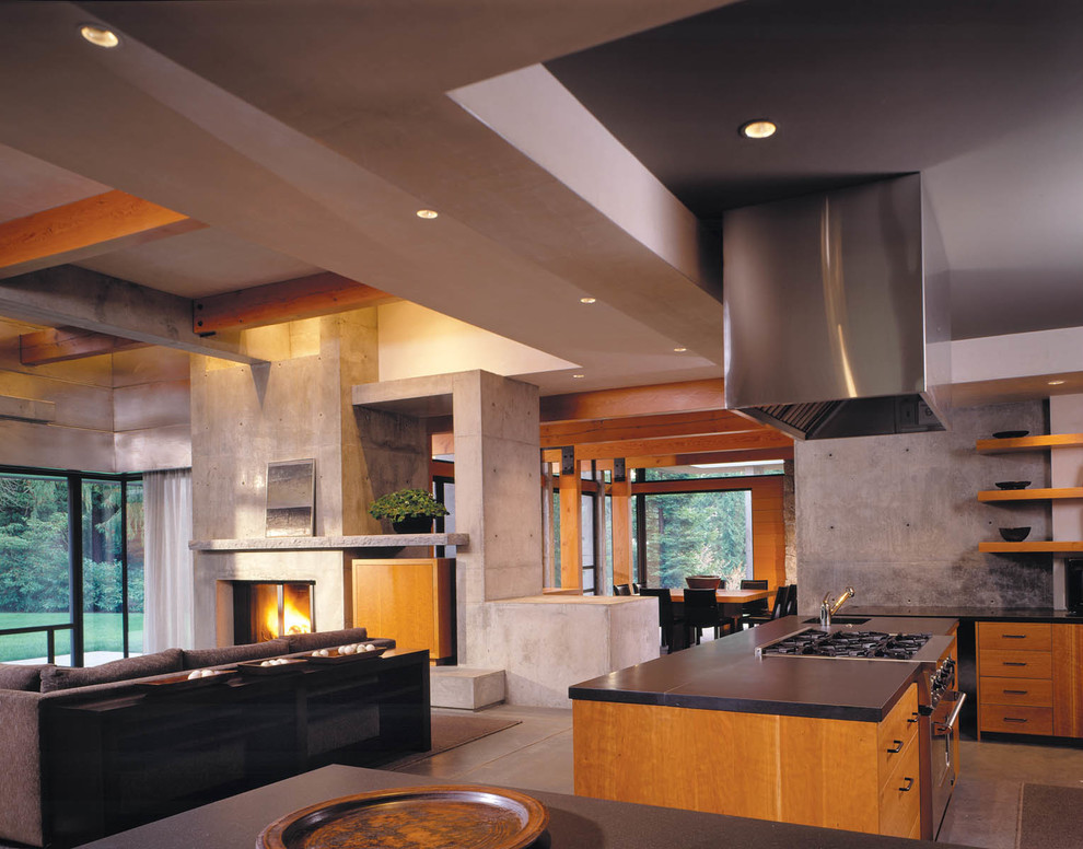 Example of a large minimalist u-shaped concrete floor open concept kitchen design in Seattle with an integrated sink, flat-panel cabinets, medium tone wood cabinets, solid surface countertops, gray backsplash, stone slab backsplash, stainless steel appliances and an island