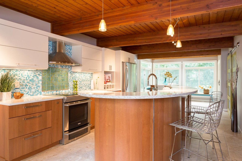 Example of a large trendy galley porcelain tile eat-in kitchen design in Boston with an undermount sink, flat-panel cabinets, black cabinets, quartz countertops, blue backsplash, glass tile backsplash, stainless steel appliances and an island