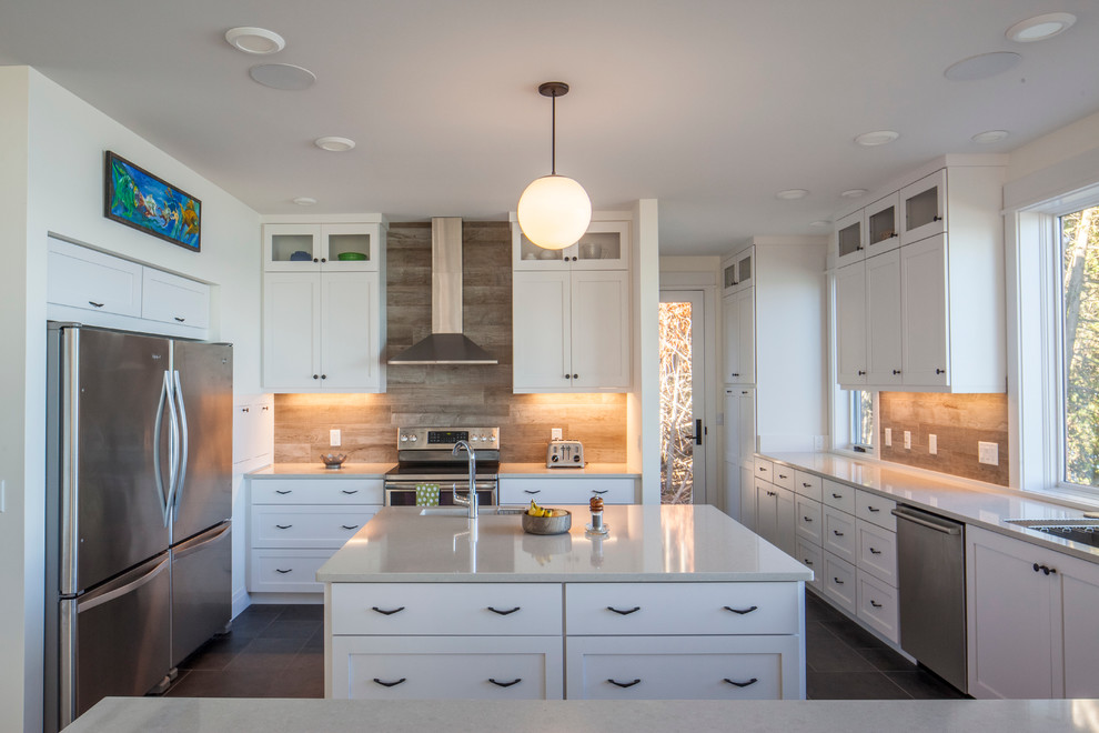 Example of a large minimalist u-shaped slate floor open concept kitchen design in Other with an undermount sink, shaker cabinets, white cabinets, quartz countertops, brown backsplash, wood backsplash, stainless steel appliances and two islands