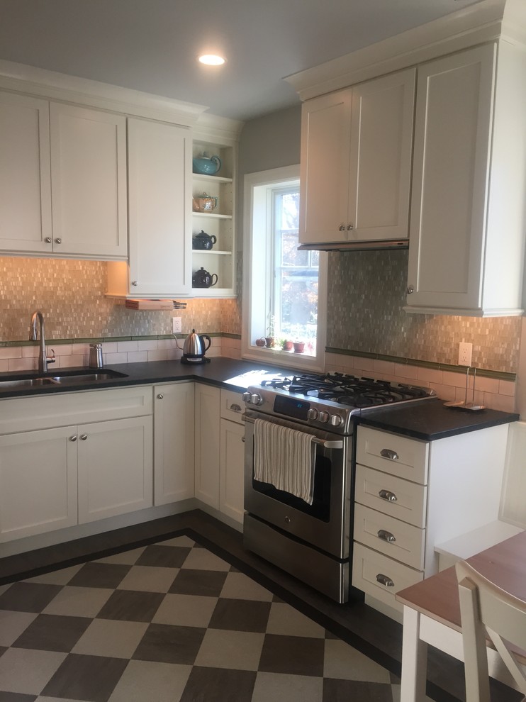 This is an example of a medium sized classic l-shaped kitchen/diner in Philadelphia with a double-bowl sink, shaker cabinets, white cabinets, soapstone worktops, white splashback, stainless steel appliances, lino flooring and no island.