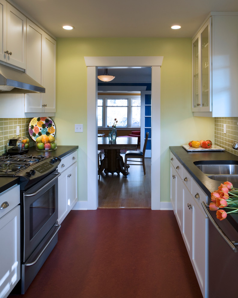 Ejemplo de cocina comedor clásica con fregadero bajoencimera, armarios estilo shaker, puertas de armario blancas, salpicadero gris, salpicadero de azulejos de cerámica y electrodomésticos de acero inoxidable