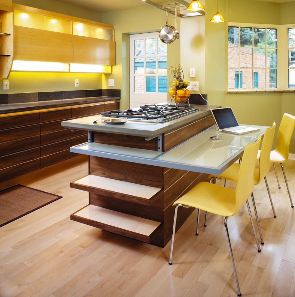 Enclosed kitchen - contemporary galley light wood floor enclosed kitchen idea in Denver with flat-panel cabinets, dark wood cabinets and an island