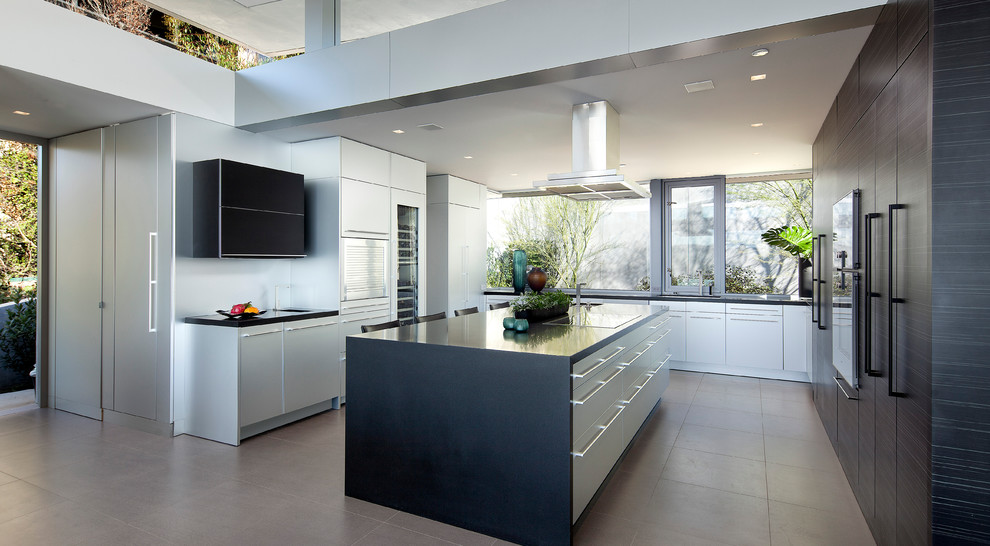 Moderne Küche in U-Form mit flächenbündigen Schrankfronten, weißen Schränken und Kücheninsel in Orange County