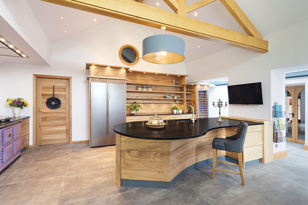 Design ideas for a large rural kitchen in Other with a submerged sink, grey floors, black worktops, open cabinets, medium wood cabinets, concrete flooring, a breakfast bar, coloured appliances, granite worktops and wood splashback.