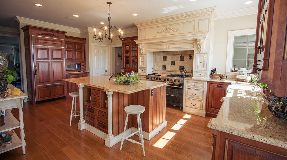 Eat-in kitchen - large traditional l-shaped light wood floor eat-in kitchen idea in Philadelphia with an undermount sink, beaded inset cabinets, granite countertops, beige backsplash, metal backsplash, stainless steel appliances and an island