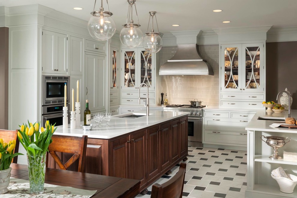 Eat-in kitchen - large traditional u-shaped porcelain tile eat-in kitchen idea in Houston with an integrated sink, recessed-panel cabinets, gray cabinets, laminate countertops, beige backsplash, glass tile backsplash, stainless steel appliances and an island