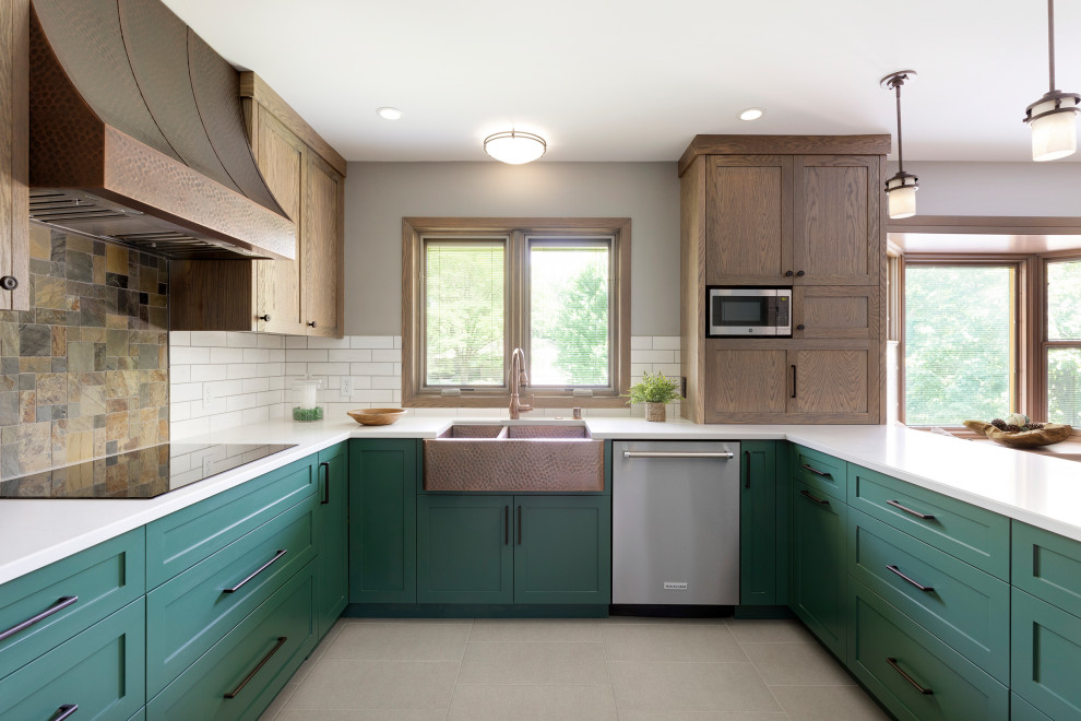 Inspiration for a mid-sized transitional u-shaped ceramic tile and gray floor eat-in kitchen remodel in Minneapolis with a farmhouse sink, shaker cabinets, green cabinets, quartz countertops, white backsplash, porcelain backsplash, stainless steel appliances, a peninsula and white countertops