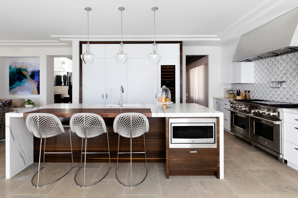 Inspiration for a medium sized modern kitchen in San Diego with a submerged sink, flat-panel cabinets, white cabinets, engineered stone countertops, multi-coloured splashback, glass tiled splashback, integrated appliances, limestone flooring, an island, grey floors and white worktops.
