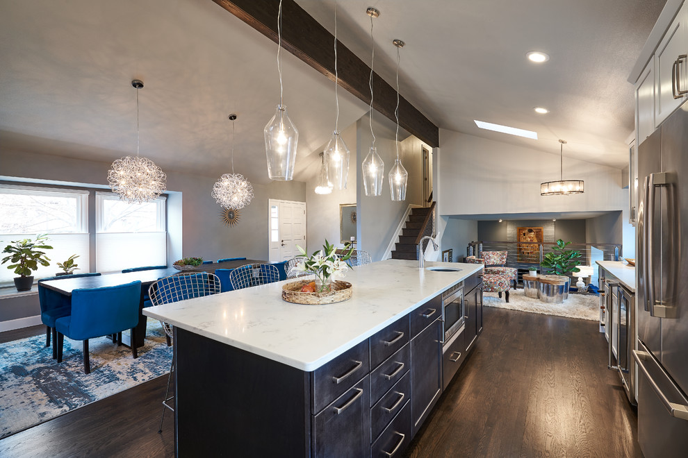 Mid-sized trendy l-shaped dark wood floor and brown floor open concept kitchen photo in Denver with an undermount sink, granite countertops, white backsplash, ceramic backsplash, stainless steel appliances, an island, shaker cabinets and white cabinets